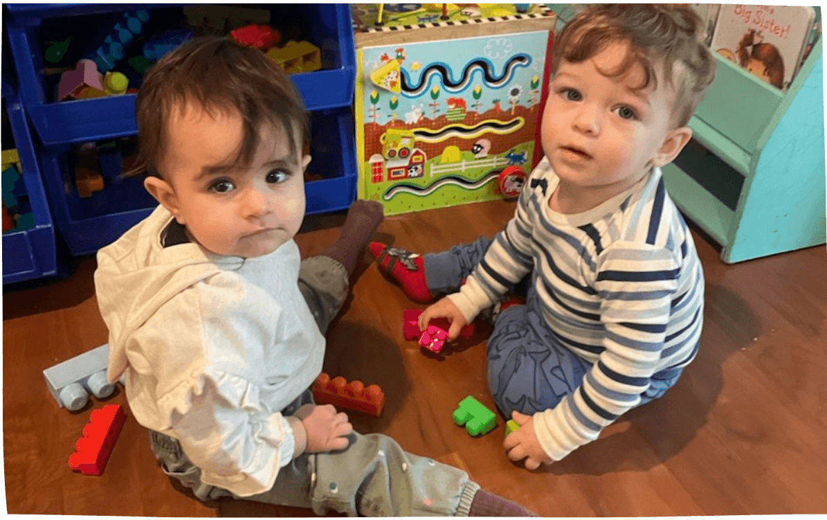 Two toddlers playing with blocks and puzzles indoors at Mama Bear Daycare, daycare in Lake Forest.